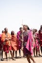 Vibrant portrayal of Maasai tribe members performing traditional dance in Kenya.